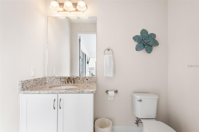 416 Southfield St, Kissimmee, FL 34747 - bathroom featuring toilet, vanity, and baseboards