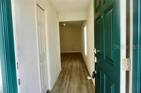 2607 Tulip Dr, Davenport, FL 33837 - corridor with baseboards and wood finished floors