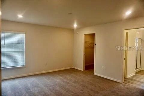 2607 Tulip Dr, Davenport, FL 33837 - carpeted spare room featuring baseboards and recessed lighting