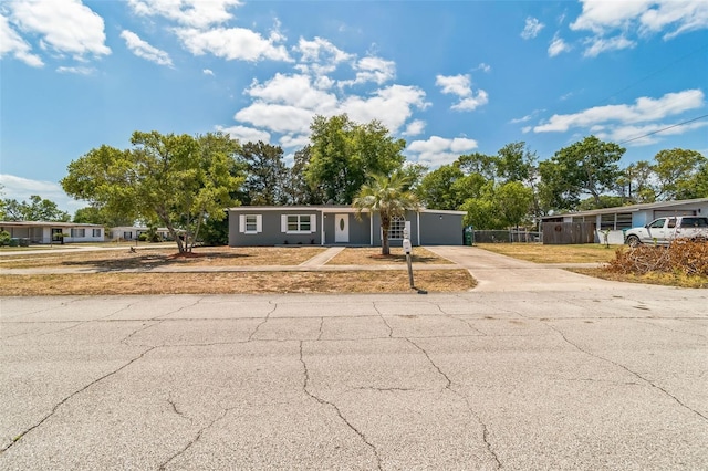 1234 Parker Ave, Deltona, FL 32725 - ranch-style home featuring concrete driveway, a garage, and fence