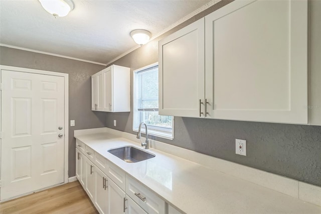 1234 Parker Ave, Deltona, FL 32725 - kitchen with light wood-style flooring, a sink, and white cabinetry