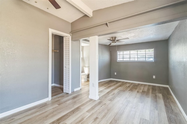 1234 Parker Ave, Deltona, FL 32725 - unfurnished bedroom with baseboards, lofted ceiling with beams, ceiling fan, and light wood-style floors