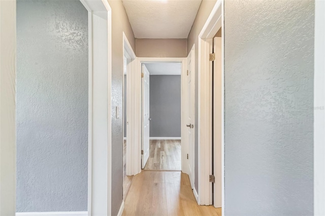 1234 Parker Ave, Deltona, FL 32725 - corridor with a textured wall, wood finished floors, and baseboards