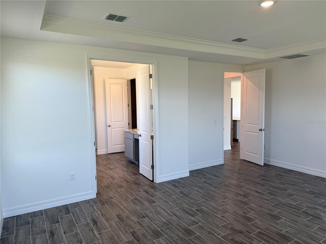 25126 Calusa Dr, Punta Gorda, FL 33955 - spare room with a raised ceiling, baseboards, dark wood finished floors, and visible vents