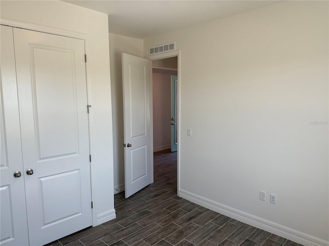 25126 Calusa Dr, Punta Gorda, FL 33955 - unfurnished bedroom with a closet, wood finish floors, baseboards, and visible vents