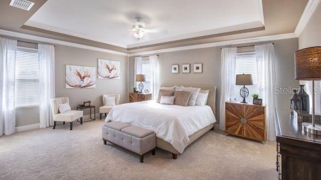 25126 Calusa Dr, Punta Gorda, FL 33955 - bedroom with visible vents, a raised ceiling, ornamental molding, multiple windows, and light carpet