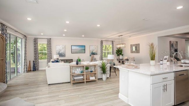 25126 Calusa Dr, Punta Gorda, FL 33955 - kitchen featuring light wood-type flooring, a healthy amount of sunlight, stainless steel dishwasher, and ornamental molding