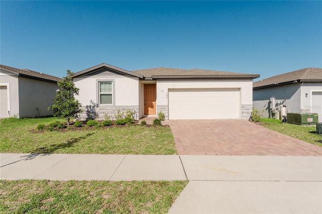 349 Guadlupe St, Haines City, FL 33844 - single story home with a front yard, a garage, decorative driveway, and stucco siding