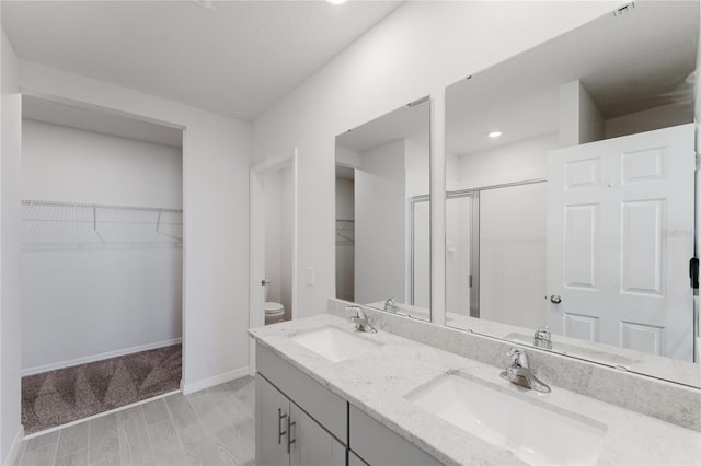 349 Guadlupe St, Haines City, FL 33844 - bathroom with a sink, toilet, double vanity, and a stall shower