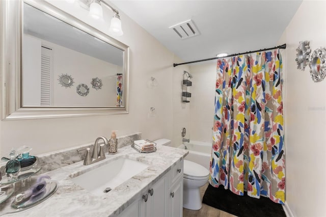 3035 Countryside Blvd Unit 15B, Clearwater, FL 33761 - bathroom featuring shower / bath combo, vanity, visible vents, and toilet