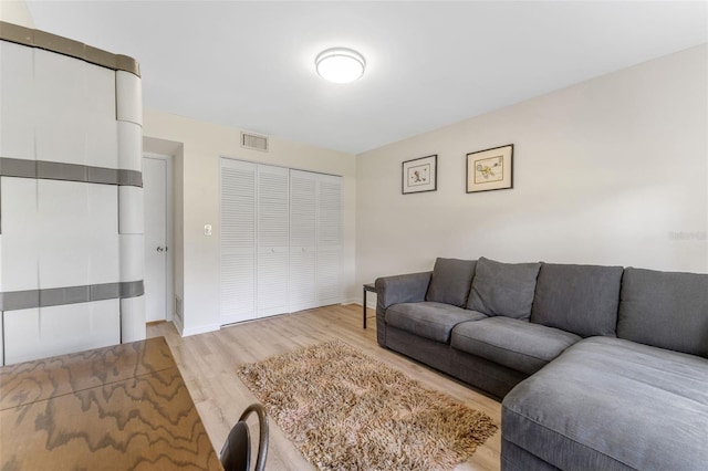 3035 Countryside Blvd Unit 15B, Clearwater, FL 33761 - living room featuring light wood-style flooring, baseboards, and visible vents
