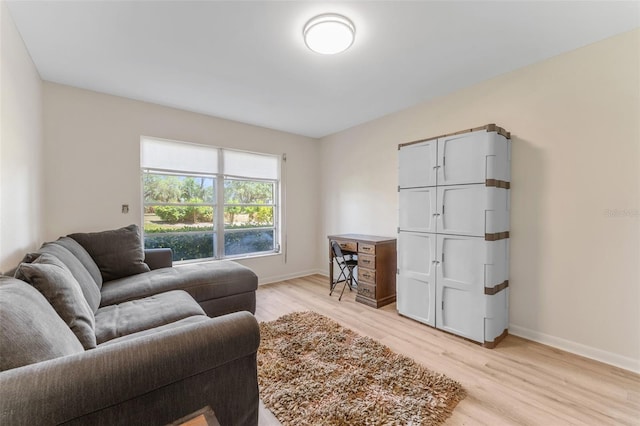 3035 Countryside Blvd Unit 15B, Clearwater, FL 33761 - living room with baseboards and light wood-type flooring