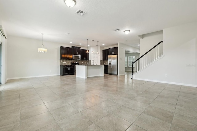 611 Marsh Reed Dr, Winter Garden, FL 34787 - unfurnished living room featuring visible vents, baseboards, light tile patterned floors, and stairs