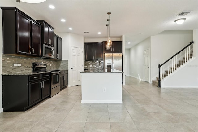 611 Marsh Reed Dr, Winter Garden, FL 34787 - kitchen with dark stone counters, tasteful backsplash, visible vents, recessed lighting, and appliances with stainless steel finishes