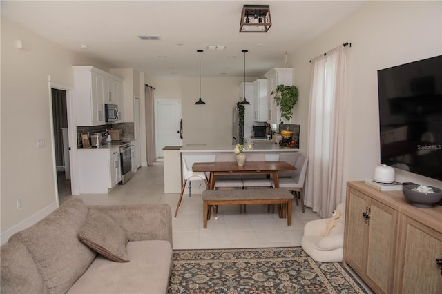 dining room with light tile patterned floors and visible vents