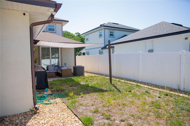 view of yard with fence, outdoor lounge area, cooling unit, and a patio
