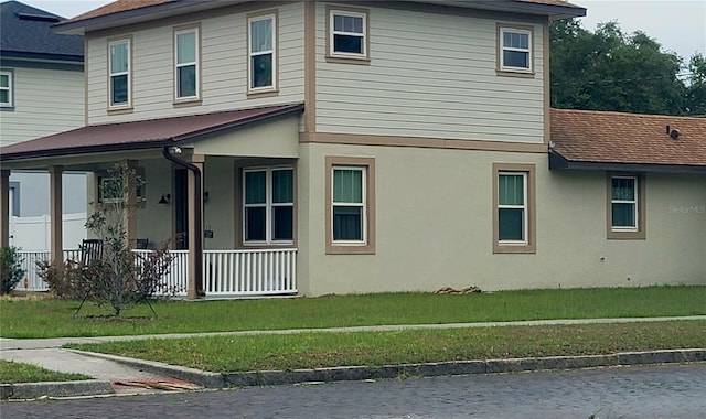 900 S Maple Ave, Sanford, FL 32771 - view of side of property featuring a porch, a lawn, and stucco siding