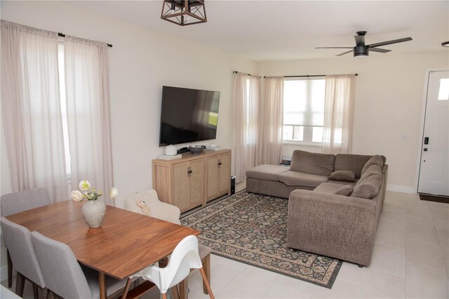900 S Maple Ave, Sanford, FL 32771 - living area with healthy amount of natural light, a ceiling fan, light tile patterned floors, and baseboards