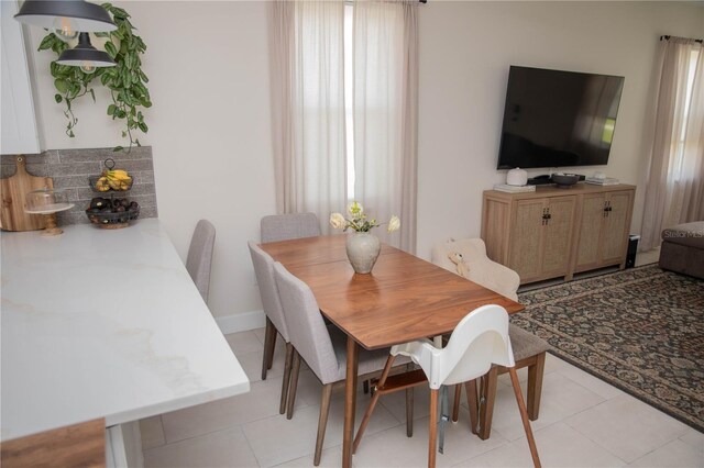 900 S Maple Ave, Sanford, FL 32771 - dining room featuring plenty of natural light, light tile patterned floors, and baseboards