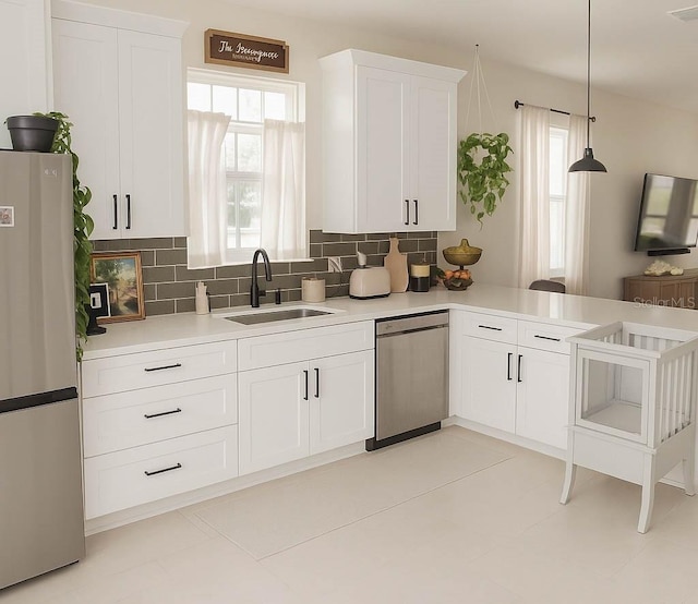 900 S Maple Ave, Sanford, FL 32771 - kitchen featuring appliances with stainless steel finishes, a sink, light countertops, and decorative backsplash