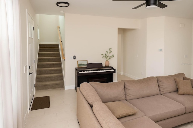 900 S Maple Ave, Sanford, FL 32771 - living room with ceiling fan, stairway, baseboards, and light tile patterned floors