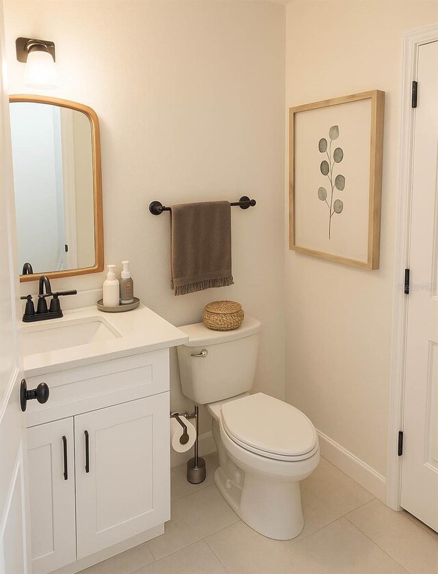 900 S Maple Ave, Sanford, FL 32771 - bathroom with tile patterned floors, toilet, vanity, and baseboards