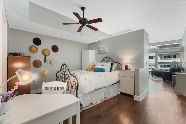 101 S Eola Dr Unit 1018, Orlando, FL 32801 - bedroom with ceiling fan, baseboards, and dark wood finished floors