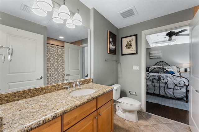 101 S Eola Dr Unit 1018, Orlando, FL 32801 - full bath with visible vents, toilet, a ceiling fan, vanity, and tile patterned floors