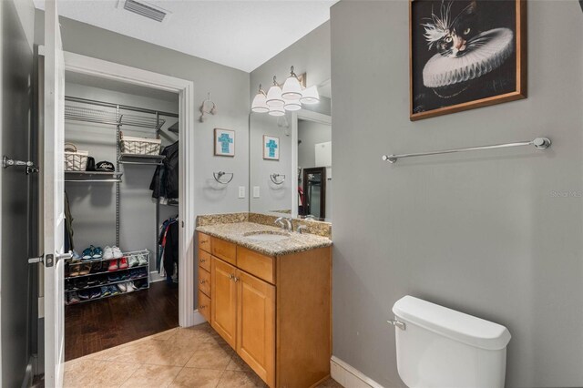 101 S Eola Dr Unit 1018, Orlando, FL 32801 - bathroom with vanity, baseboards, tile patterned flooring, toilet, and visible vents