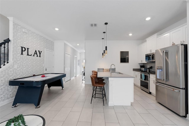 2400 Reading Trl, Kissimmee, FL 34746 - interior space featuring a sink, wallpapered walls, a breakfast bar area, appliances with stainless steel finishes, and visible vents