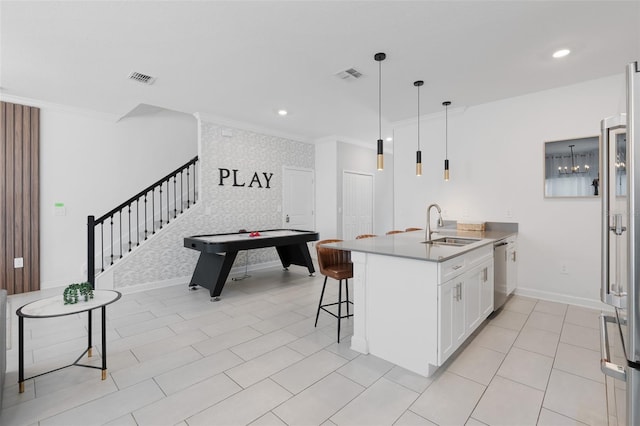 2400 Reading Trl, Kissimmee, FL 34746 - kitchen featuring stainless steel dishwasher, visible vents, a sink, and crown molding