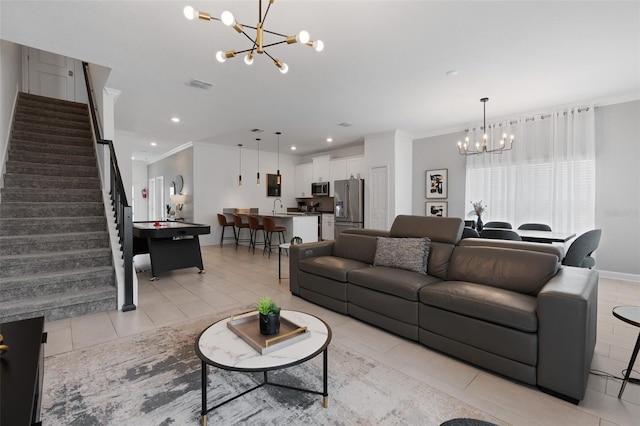 2400 Reading Trl, Kissimmee, FL 34746 - living room featuring an inviting chandelier, visible vents, ornamental molding, light tile patterned flooring, and stairs