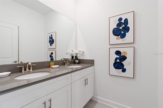 2400 Reading Trl, Kissimmee, FL 34746 - full bath with tile patterned floors, baseboards, a sink, and double vanity