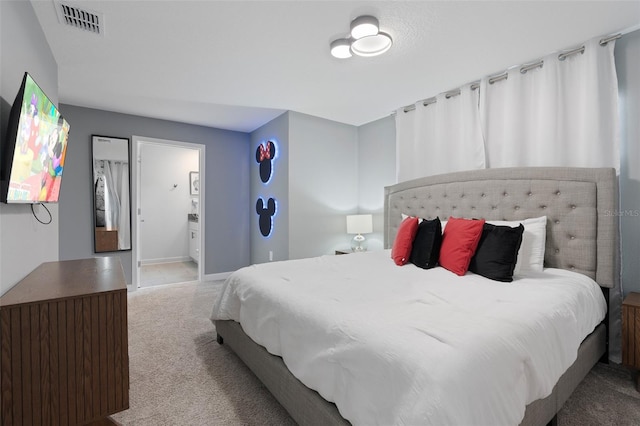 2400 Reading Trl, Kissimmee, FL 34746 - carpeted bedroom featuring visible vents, baseboards, and ensuite bathroom