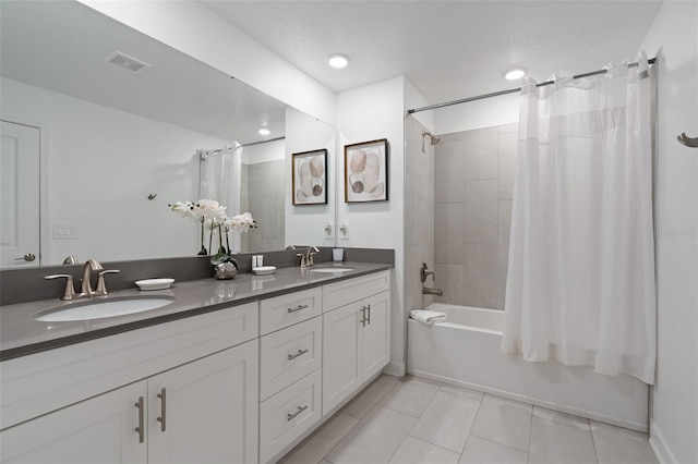 2400 Reading Trl, Kissimmee, FL 34746 - bathroom featuring shower / bath combination with curtain, tile patterned flooring, a sink, and visible vents