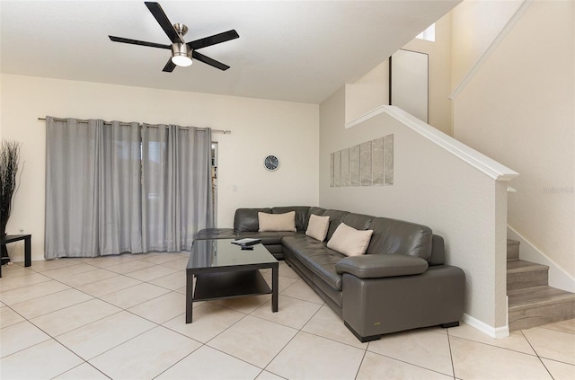 living room with stairway, baseboards, light tile patterned floors, and ceiling fan