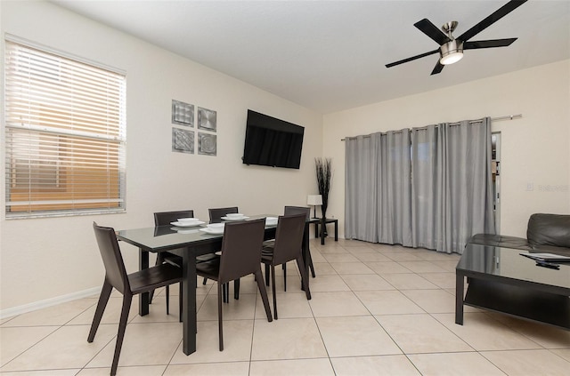 dining area with baseboards, a ceiling fan, and light tile patterned flooring