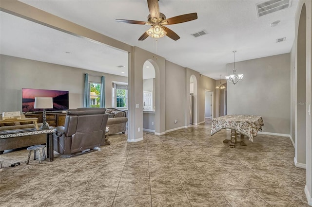 living area featuring arched walkways and visible vents