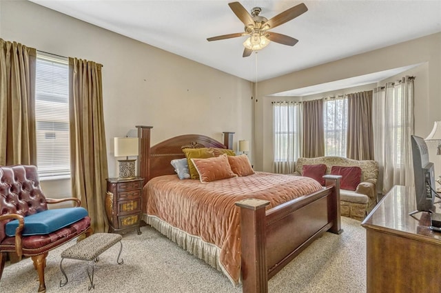 bedroom with light carpet and a ceiling fan