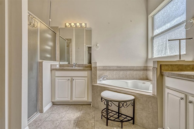 full bathroom with a shower stall, tile patterned flooring, a sink, a bath, and two vanities