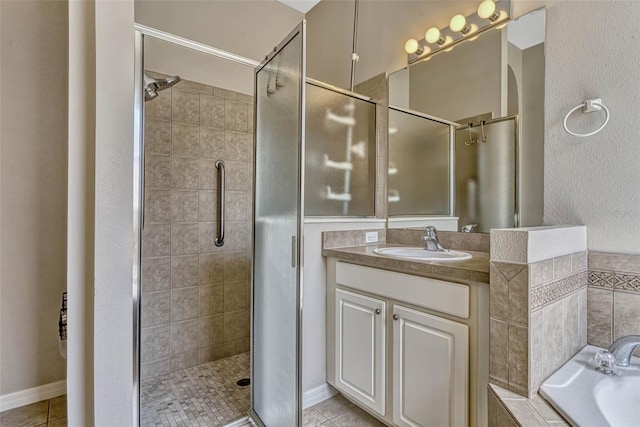 bathroom featuring a bath, tile patterned floors, vanity, and a stall shower