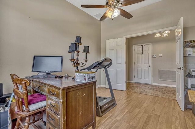 home office featuring ceiling fan, light wood-style flooring, baseboards, lofted ceiling, and visible vents