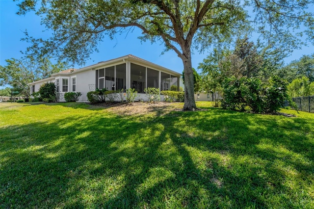 exterior space with fence and a sunroom