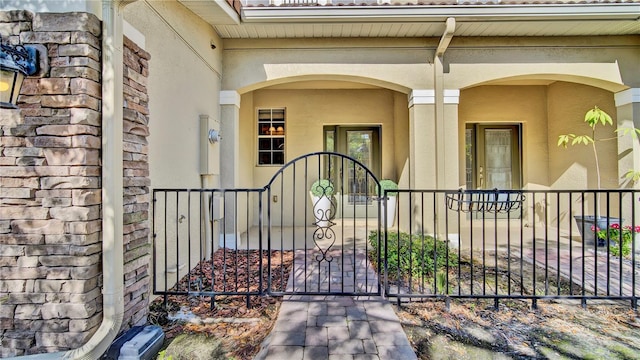 2167 Velvet Leaf Dr, Ocoee, FL 34761 - doorway to property featuring fence, a gate, and stucco siding