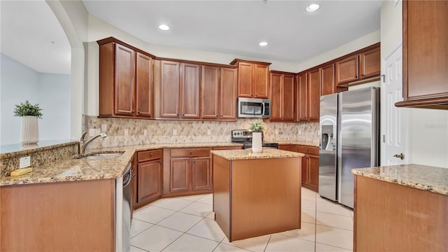 2167 Velvet Leaf Dr, Ocoee, FL 34761 - kitchen featuring backsplash, appliances with stainless steel finishes, a sink, and light stone counters