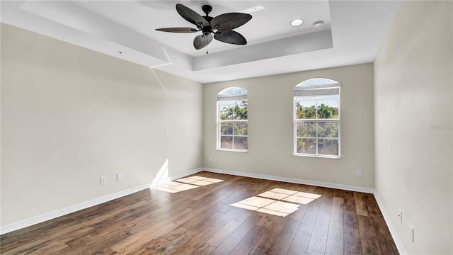 2167 Velvet Leaf Dr, Ocoee, FL 34761 - unfurnished room featuring a raised ceiling, baseboards, a ceiling fan, and hardwood / wood-style flooring