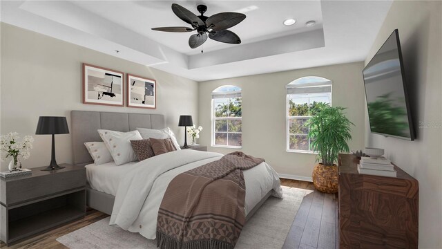 2167 Velvet Leaf Dr, Ocoee, FL 34761 - bedroom featuring baseboards, ceiling fan, a tray ceiling, recessed lighting, and wood finished floors