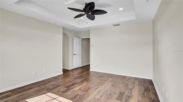 2167 Velvet Leaf Dr, Ocoee, FL 34761 - empty room featuring visible vents, baseboards, a raised ceiling, a ceiling fan, and wood finished floors