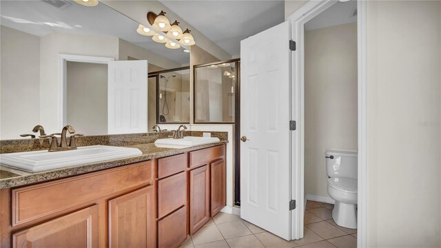 2167 Velvet Leaf Dr, Ocoee, FL 34761 - bathroom with a shower stall, double vanity, a sink, and tile patterned flooring