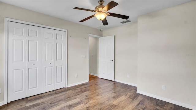2167 Velvet Leaf Dr, Ocoee, FL 34761 - unfurnished bedroom with ceiling fan, a closet, visible vents, wood finished floors, and baseboards